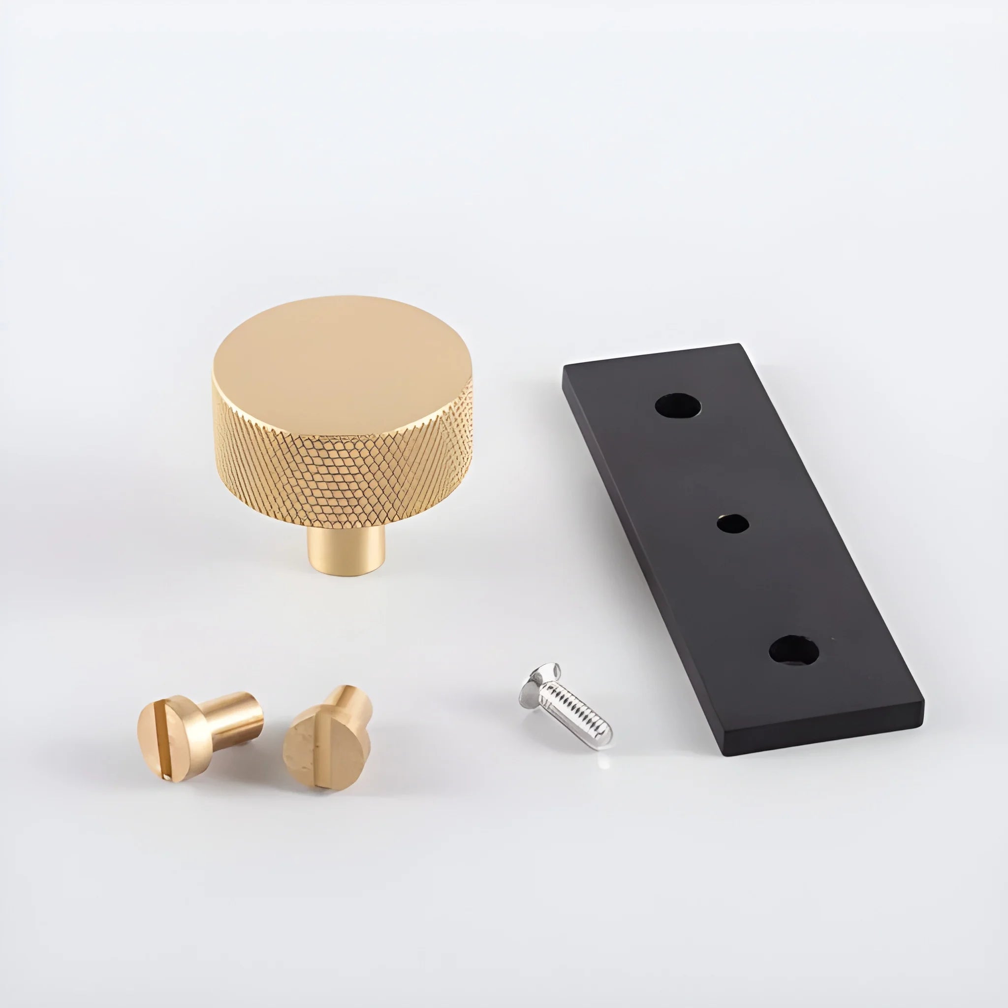 The Mantara B-0118 is a modern brass knob in gold with a black stabiliser base, ideal for kitchen and dresser drawers.