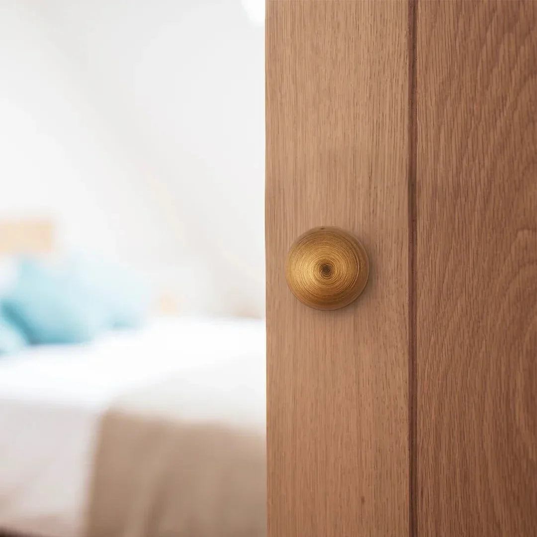 The Mantara B-0001 Zenith Knob is a modern brass knob in brushed bronze, perfect for wardrobes, cabinets, and drawers.