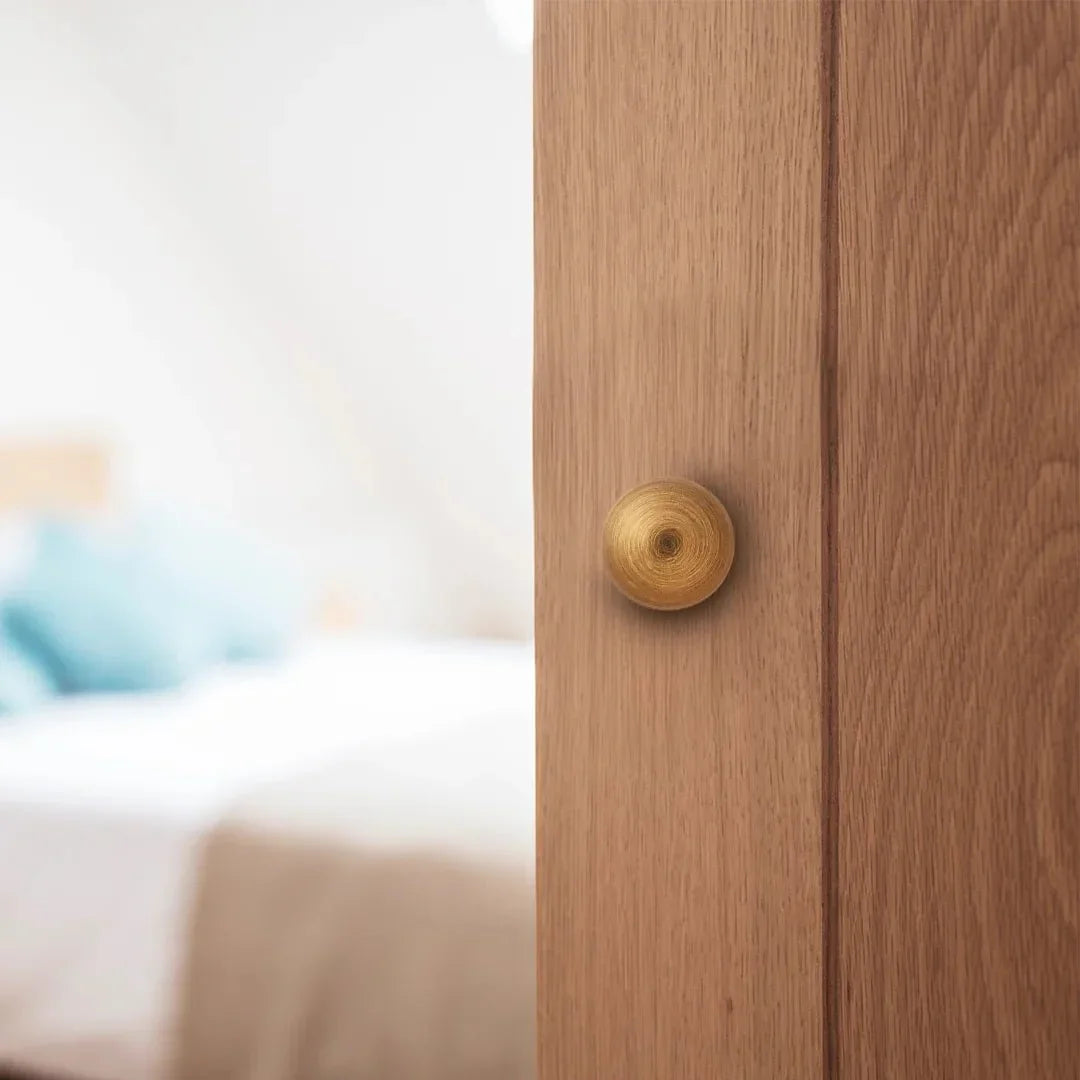 The Mantara B-0001 Zenith Knob is a modern brass knob in brushed bronze, perfect for wardrobes, cabinets, and drawers.