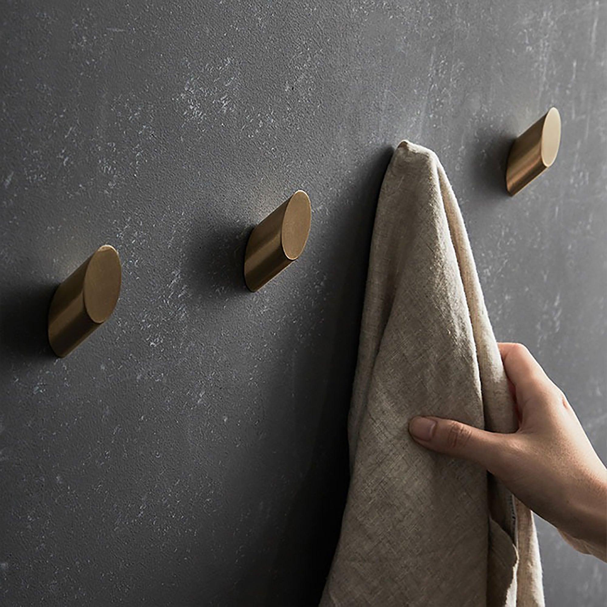 Mantara Hexa Hook B-0091 is a modern brushed brass wall hook in gold, perfect for bathrooms, bedrooms, and living areas.