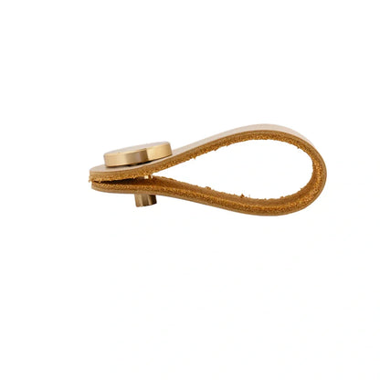 The Mantara L-0001 Maverick Pull Knob is a Nordic leather and brass knob in cream, ideal for kitchens and furniture.