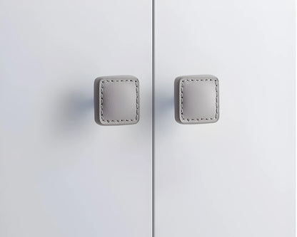 The Mantara L-0008 Sofia Square Knob is a modern leather knob in grey, perfect for cabinets and drawers.