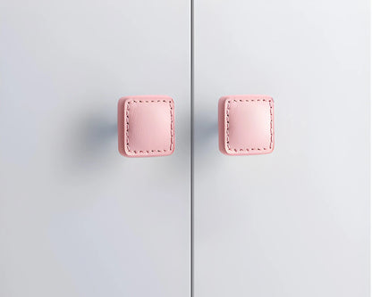 The Mantara L-0008 Sofia Square Knob is a modern leather knob in pink, perfect for cabinets and drawers.