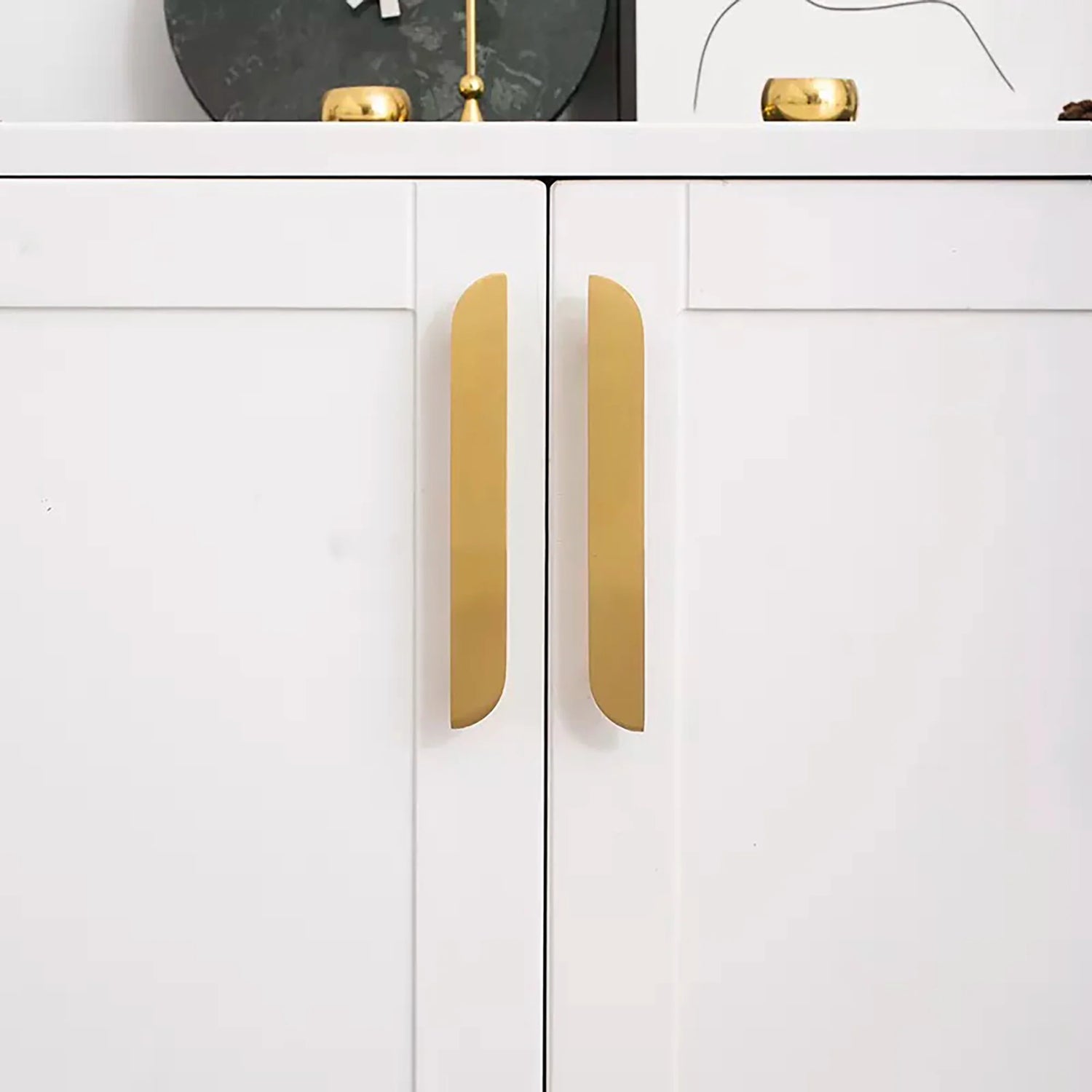 The Tarang hanlde by Mantara (B-0104) is a brushed brass modern pair knob in gold, perfect for wardrobes, doors, and kitchens.