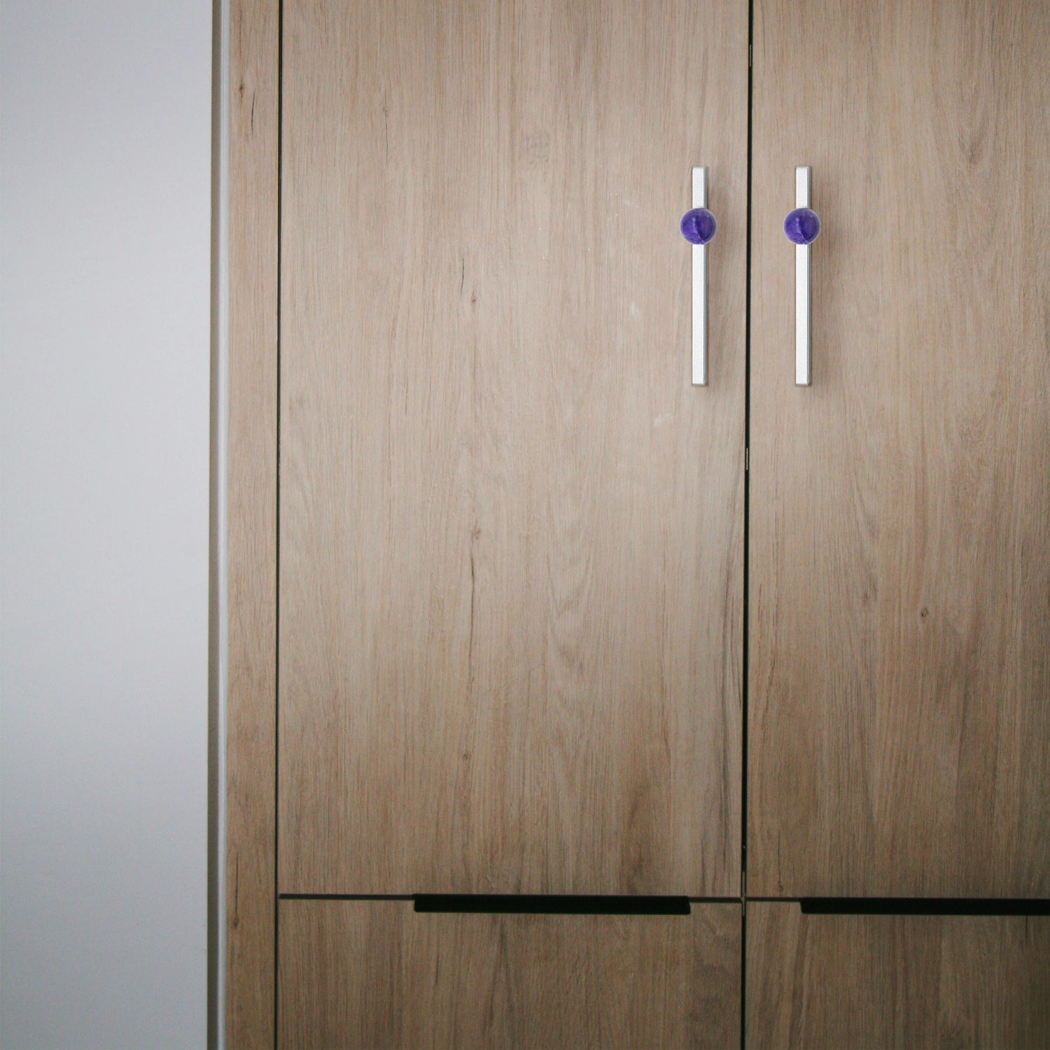 Wooden wardrobe with two doors and two handles on a neutral background