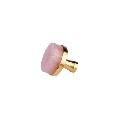A modern cabinet knob featuring a round, polished pink stone top set in a brushed gold metal frame and cylindrical base, shown on a plain white background.
