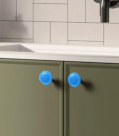 The Mantara L-0008 Sofia Round Knob is a modern leather knob in blue, ideal for cabinets and wardrobes.