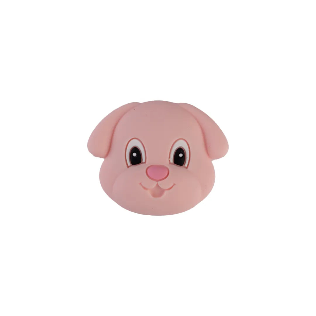 A pink plastic dog head toy with large black eyes, white highlights, and a pink nose, shown against a plain white background.