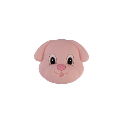 A pink plastic dog head toy with large black eyes, white highlights, and a pink nose, shown against a plain white background.