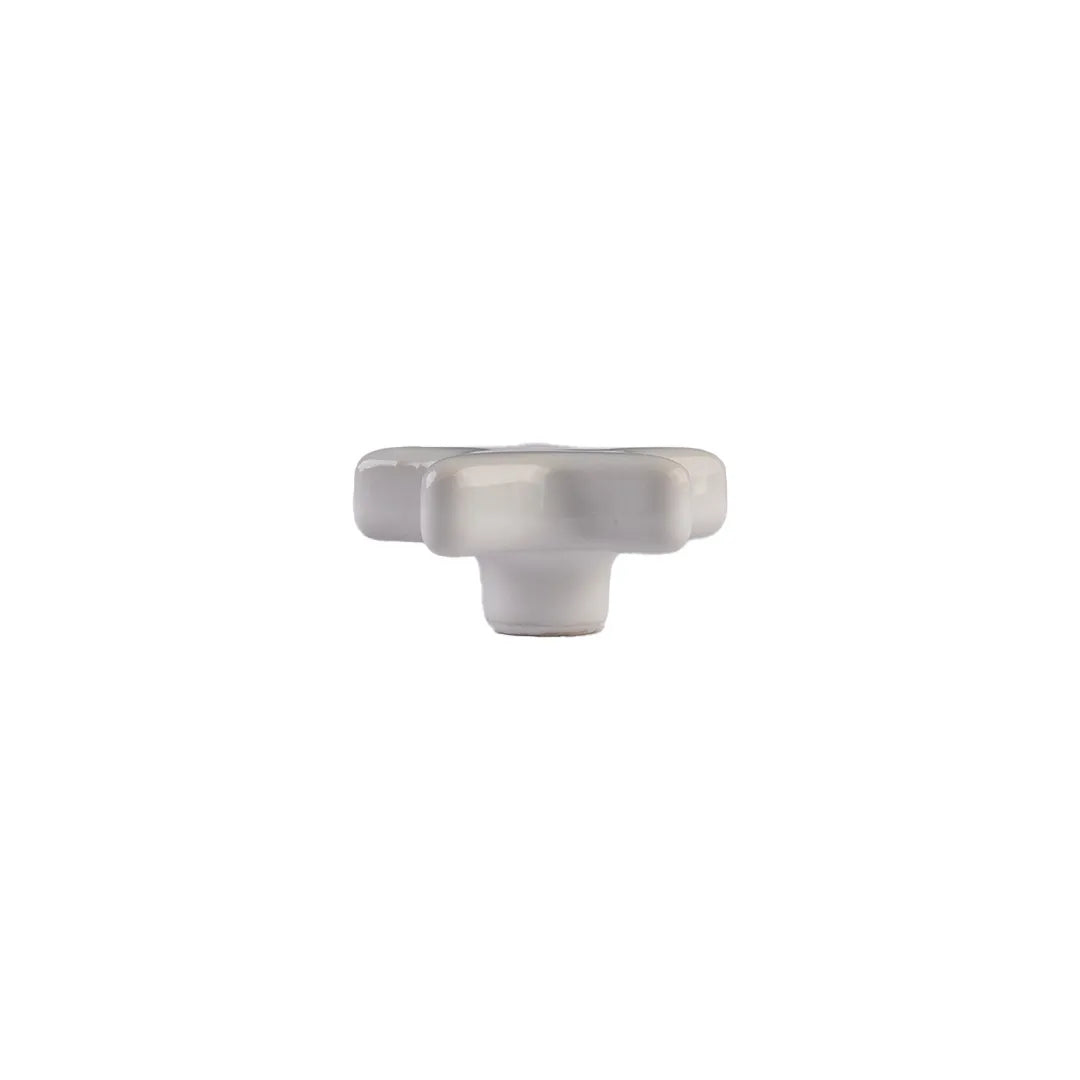 A single white ceramic cabinet knob with a textured, ribbed design, shown against a plain white background.