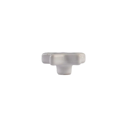 A single white ceramic cabinet knob with a textured, ribbed design, shown against a plain white background.