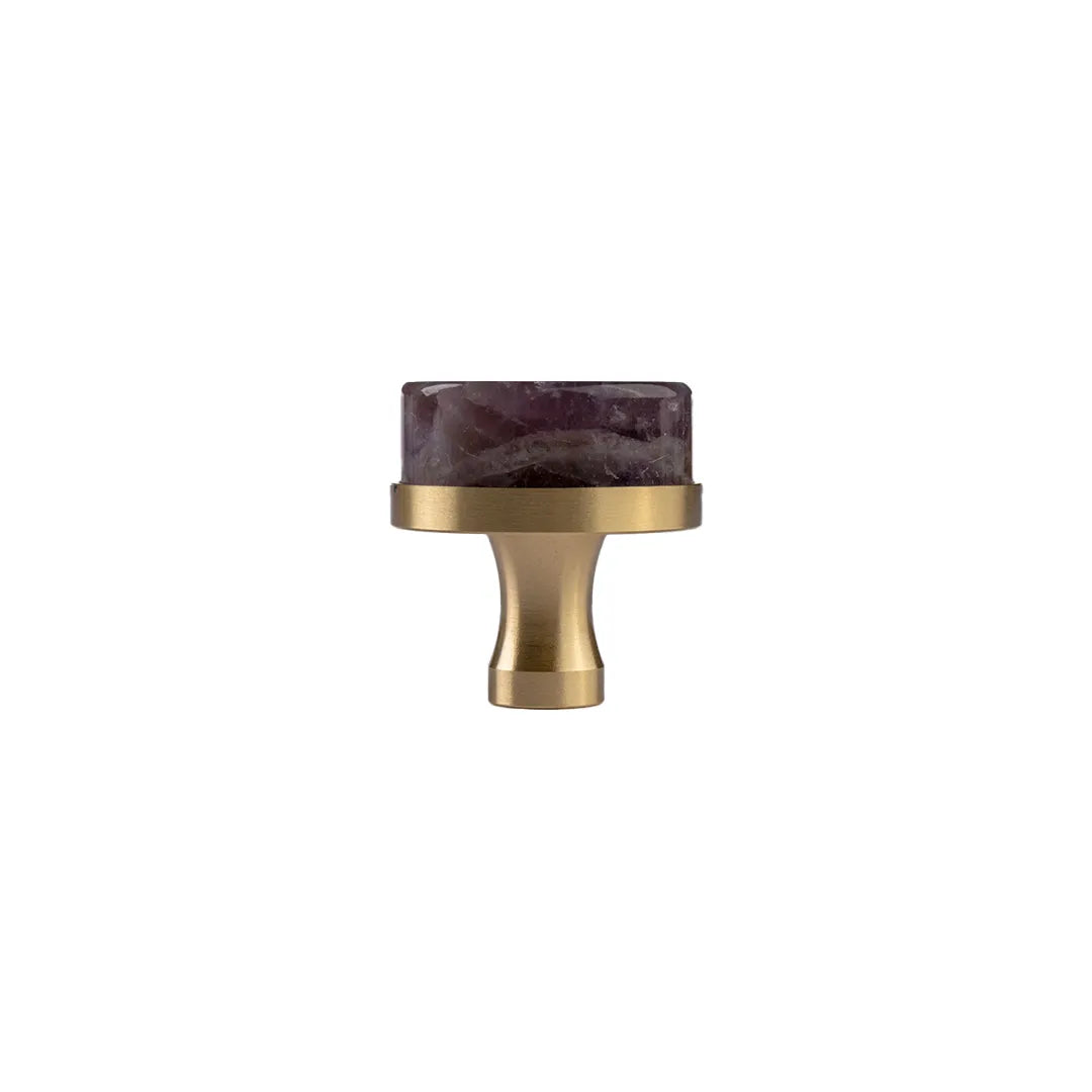 A modern cabinet knob featuring a brushed brass finished metal base and a rectangular dark purple agate stone inlay on top, shown against a solid white background.