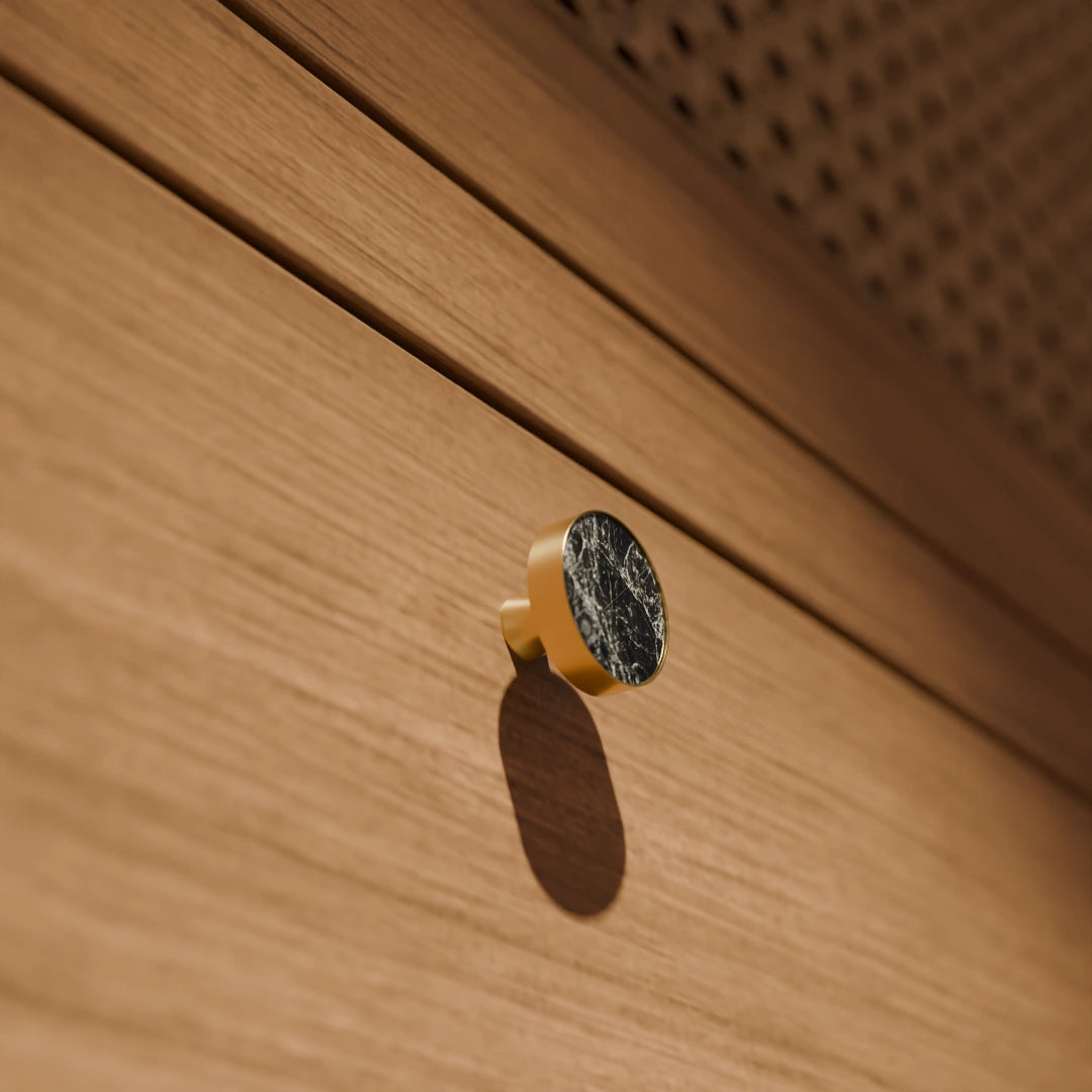 The Mantara M-0004 Carrara Knob is a modern stone and brass knob in shimmer stone, ideal for drawers and cabinets.