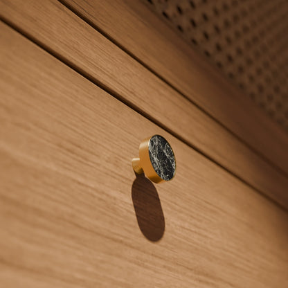 The Mantara M-0004 Carrara Knob is a modern stone and brass knob in shimmer stone, ideal for drawers and cabinets.