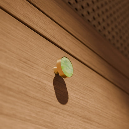 The Mantara M-0004 Carrara Knob is a modern stone and brass knob in  Indian Jade, ideal for drawers and cabinets.