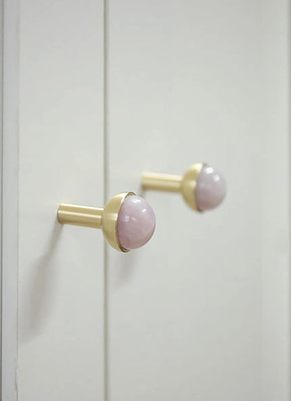 The Mantara C-0006 is a modern crystal + brass knob in pink, ideal for drawers and cabinets.