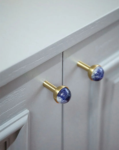 The Mantara C-0006 is a modern crystal + brass knob in blue, ideal for drawers and cabinets.