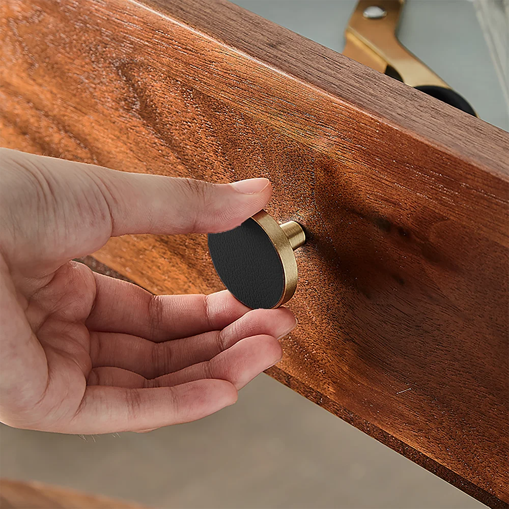 The Mantara L-0004 Obsidian Knob is a modern brass and leather knob in black, perfect for wardrobes, kitchens, and cabinets.