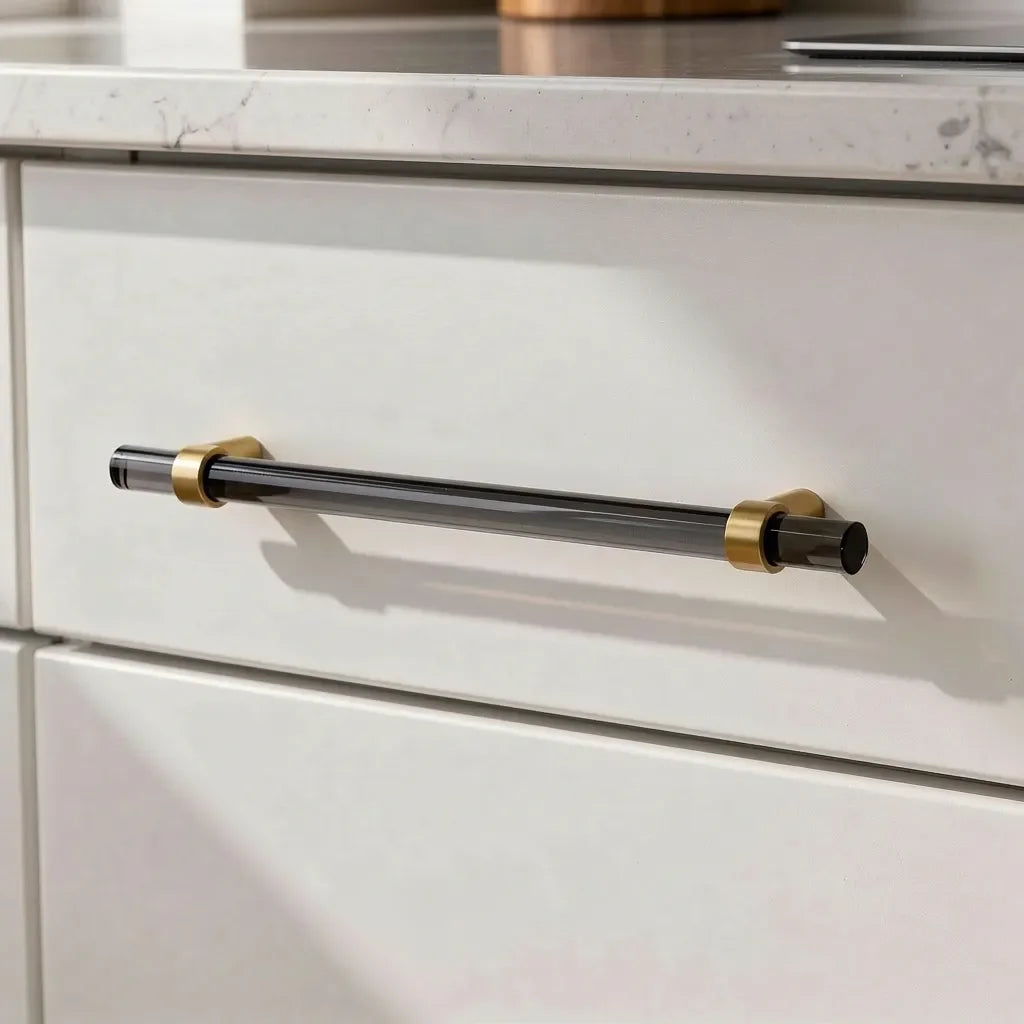 The Mantara A-0011 Petra V Handle is a modern grey acrylic and brass handle with polished finish, perfect for doors, cabinets, and wardrobes.
