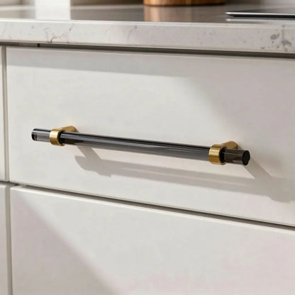 The Mantara A-0011 Petra V Handle is a modern grey acrylic and brass handle with polished finish, perfect for doors, cabinets, and wardrobes.