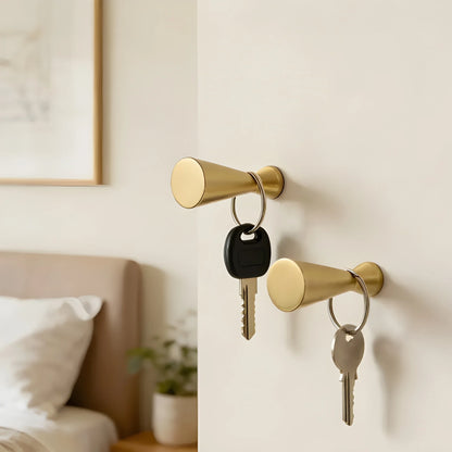 Mantara Elani Hook B-0094 is a modern brushed brass wall hook in gold, ideal for bathrooms, bedrooms, and living spaces.
