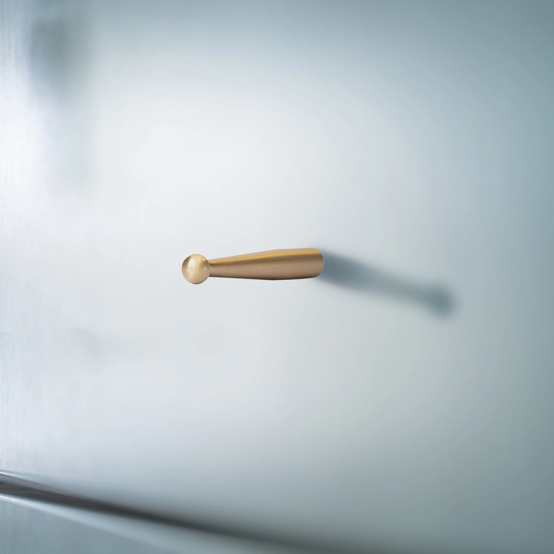Mantara Mateo Hook B-0095 is a modern brushed brass wall hook in gold, ideal for bathrooms, bedrooms, hotels, and living rooms.