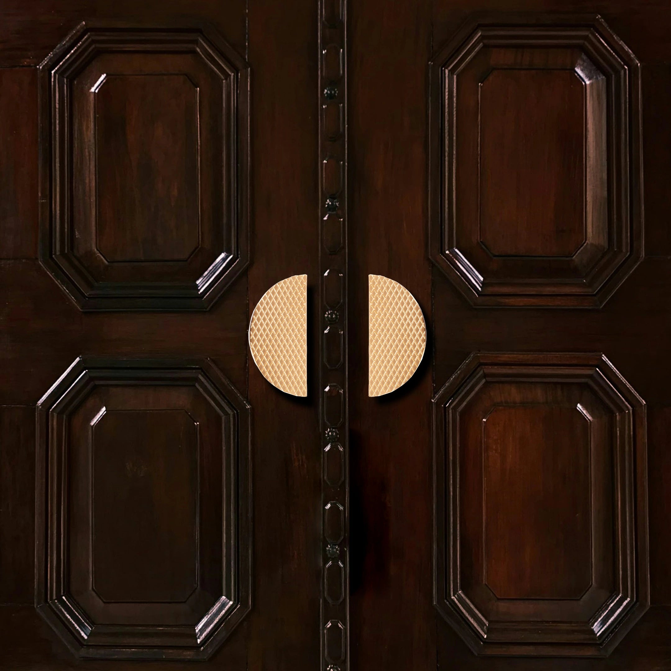 Wooden door with decorative carved panels and a central handle, offering a classic statement piece by Mantara.