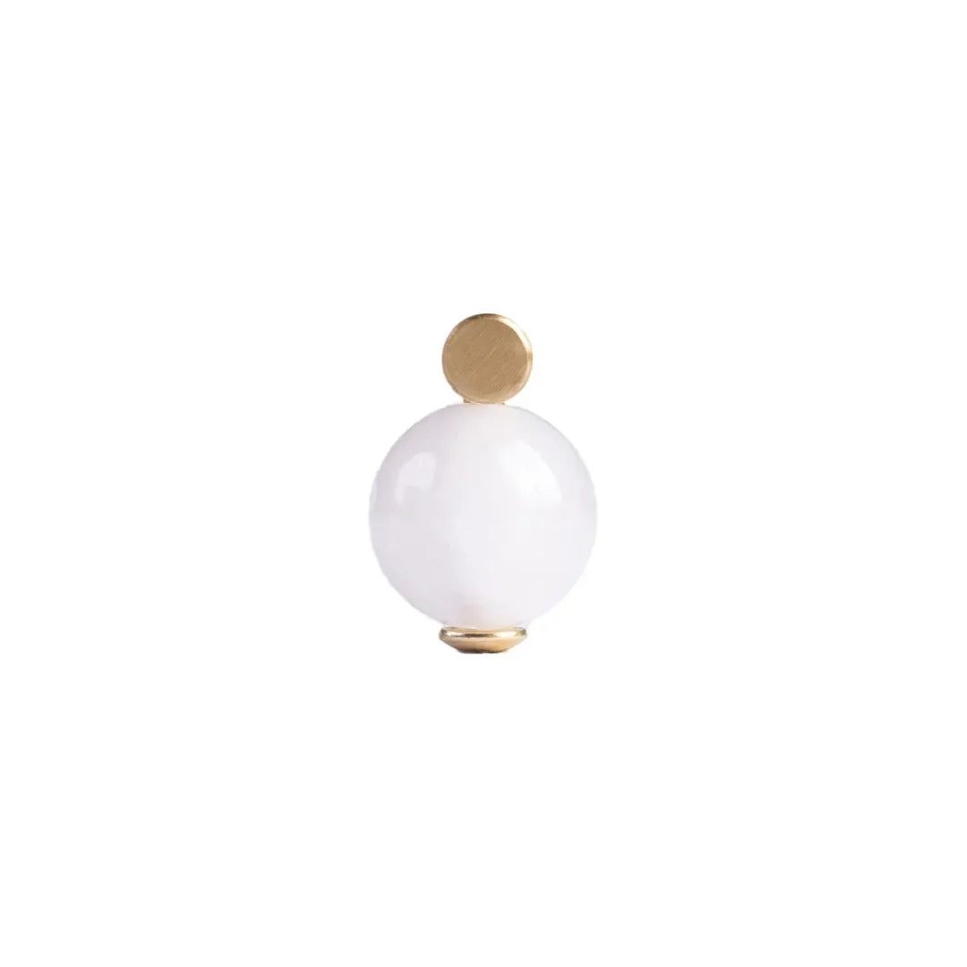 The Mantara C-0022 Solstice Handle is a modern crystal and brass handle in white, ideal for wardrobes, drawers, and cabinets.