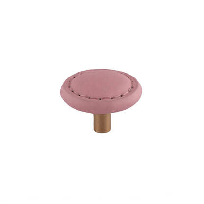 The Mantara L-0008 Sofia Round Knob is a modern leather knob in pink, ideal for cabinets and wardrobes.