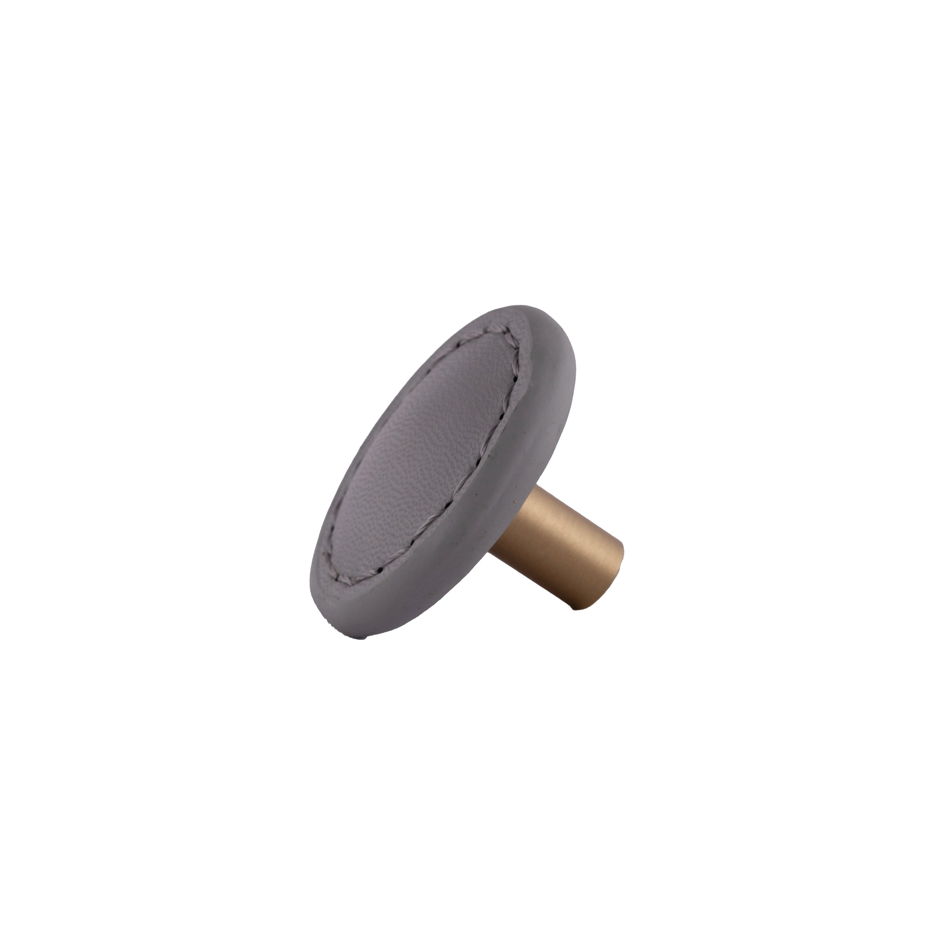 The Mantara L-0008 Sofia Round Knob is a modern leather knob in grey, ideal for cabinets and wardrobes.