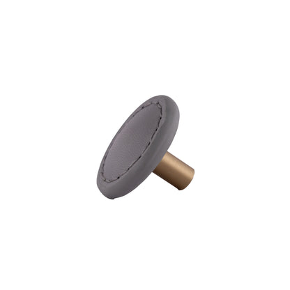 The Mantara L-0008 Sofia Round Knob is a modern leather knob in grey, ideal for cabinets and wardrobes.