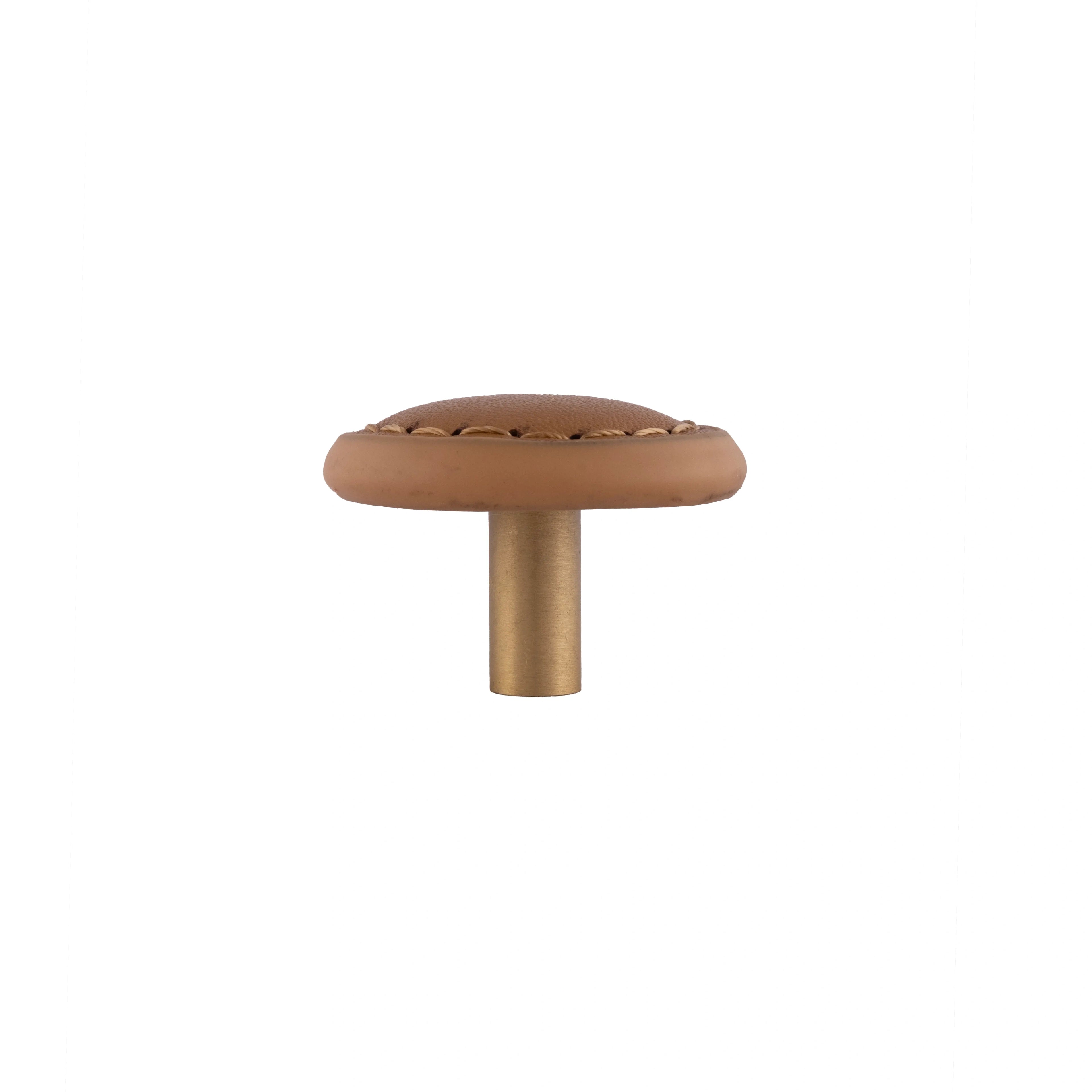 The Mantara L-0008 Sofia Round Knob is a modern leather knob in brown, ideal for cabinets and wardrobes.