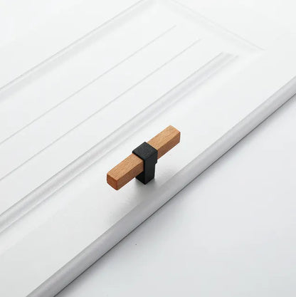 Mantara Lorien Handle W-0028 is a modern zinc and beech wood Tbar in black ideal for kitchen and dresser drawers.