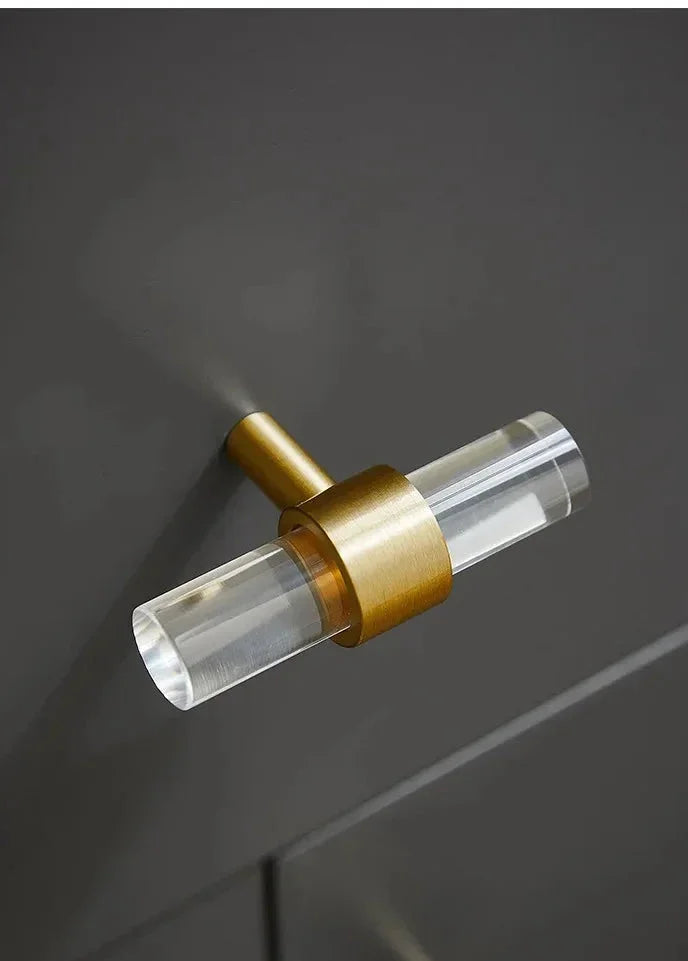 A sleek T-bar handle, Petra II made of clear acrylic with brushed brass supports in transparent white finish, model A-0008 by Mantara, A-0008.