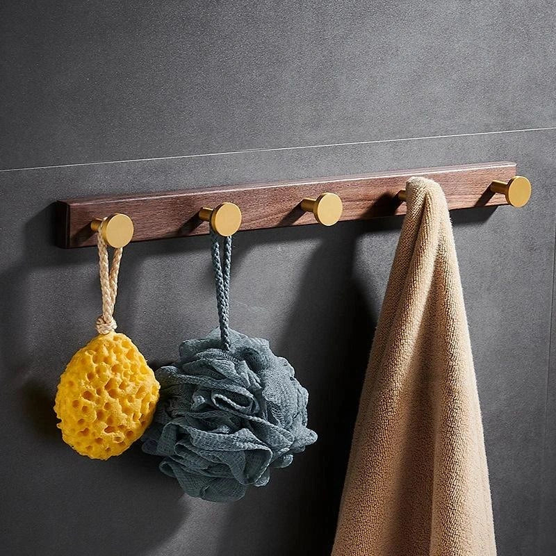 Mantara Calista Hook W-0011 is a modern walnut wood &amp; brass wall hook in gold with brushed finish, ideal for homes &amp; hotels.