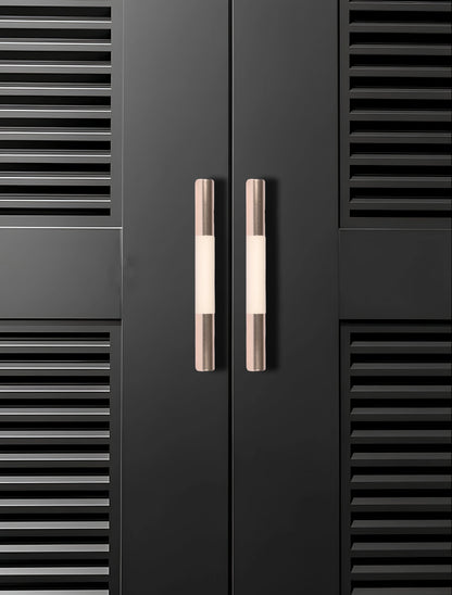 Black cabinet with sleek metallic handles set against a black background, offering a bold modern look by Mantara.