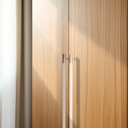 Wooden wardrobe with two doors and metallic handles, set against a white background for a clean look by Mantara.