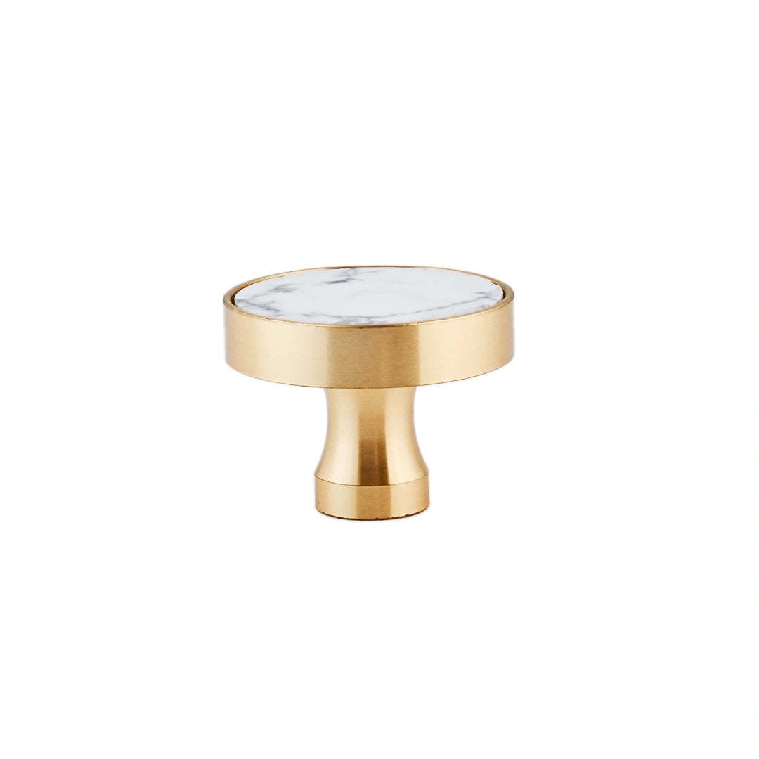 The Mantara M-0004 Carrara Knob is a modern stone and brass knob in white, ideal for drawers and cabinets.