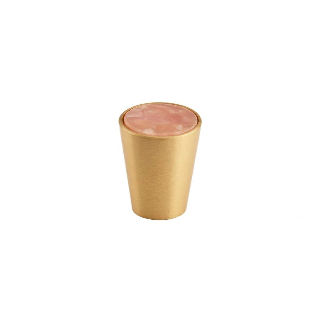 Gold tumbler with pink interior on a white background