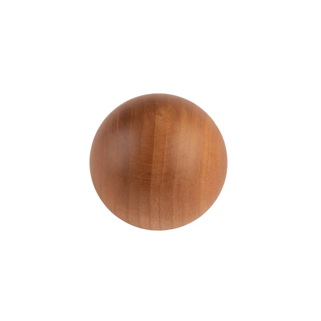 A round wooden knob with a smooth, polished finish and visible wood grain, centered on a plain white background.