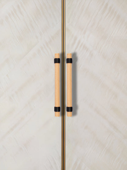 Close-up of a door with wooden handles, set against a textured white background—natural warmth meets simplicity by Mantara.