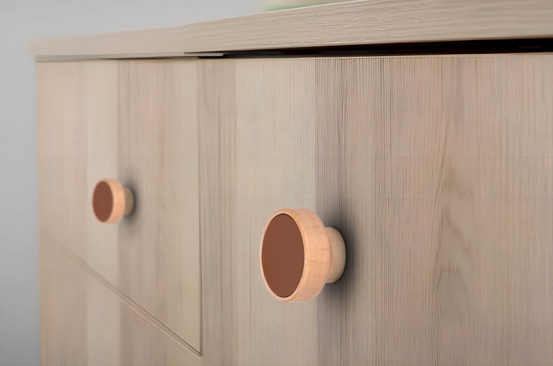 Wooden cabinet with round wooden knobs, set against a light gray background—simple and warm design by Mantara.