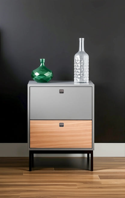 Two-toned dresser with a wooden base, gray top, and subtle knobs, styled with two decorative bottles—by Mantara.
