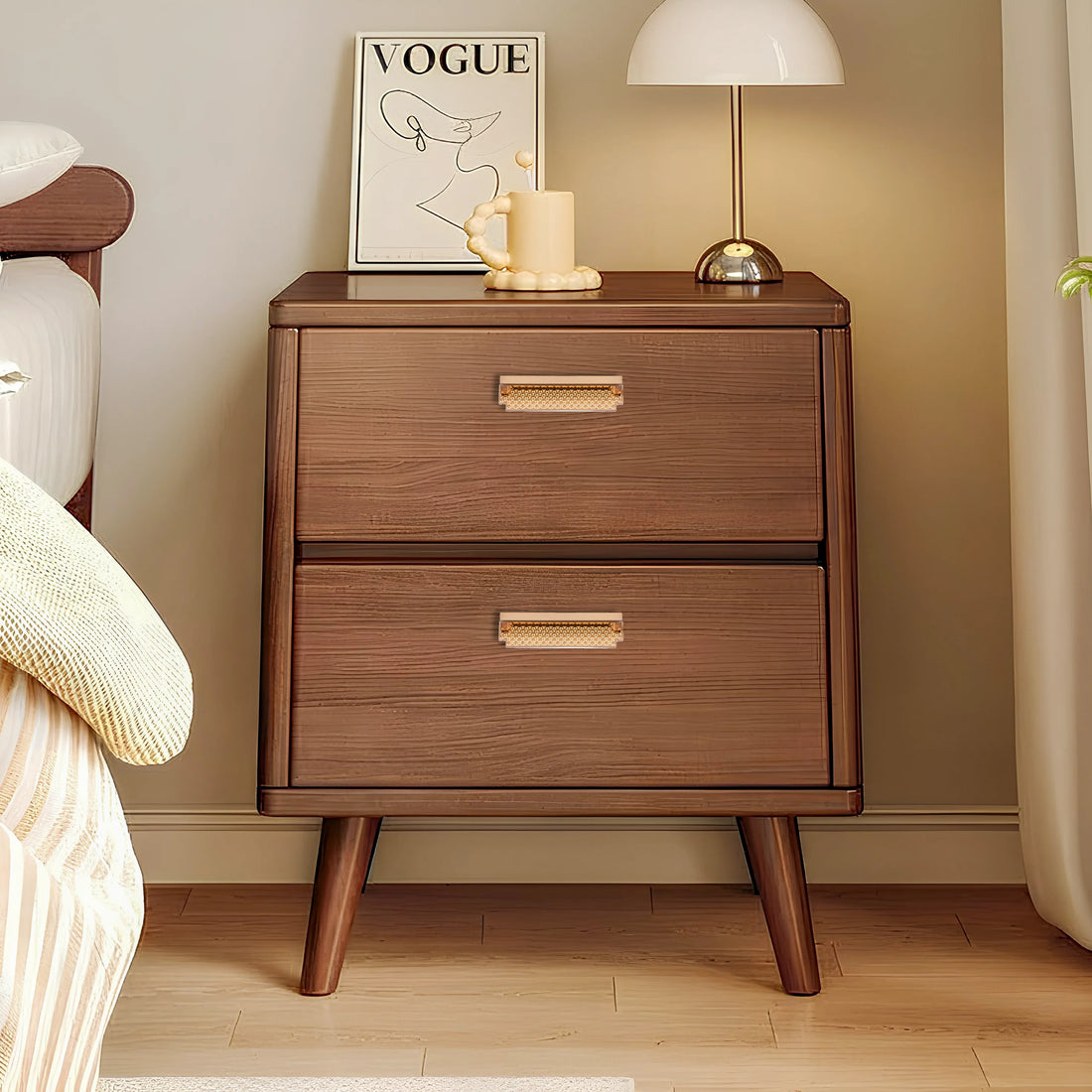 Wooden nightstand with a white marble top and sleek handle, styled with green flowers in a vase next to a bed—by Mantara.