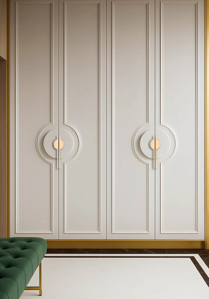 Decorative wall panel with circular designs and gold accents, paired with a green sofa in a styled setting—by Mantara.