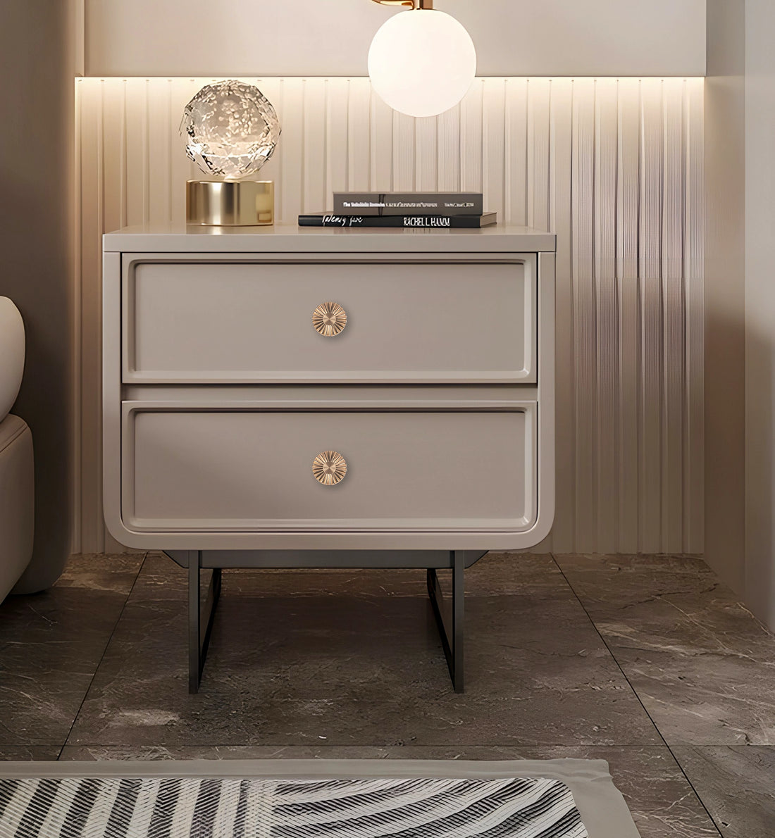 Beige nightstand with two drawers and gold knobs, styled in a warm and minimal room setting—elegant storage by Mantara.

