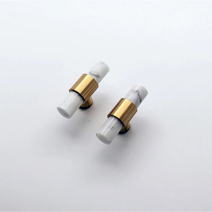 Arabella T Bar Handles in black, gold, white, and gray displayed on a pink background, showcasing modern style by Mantara.