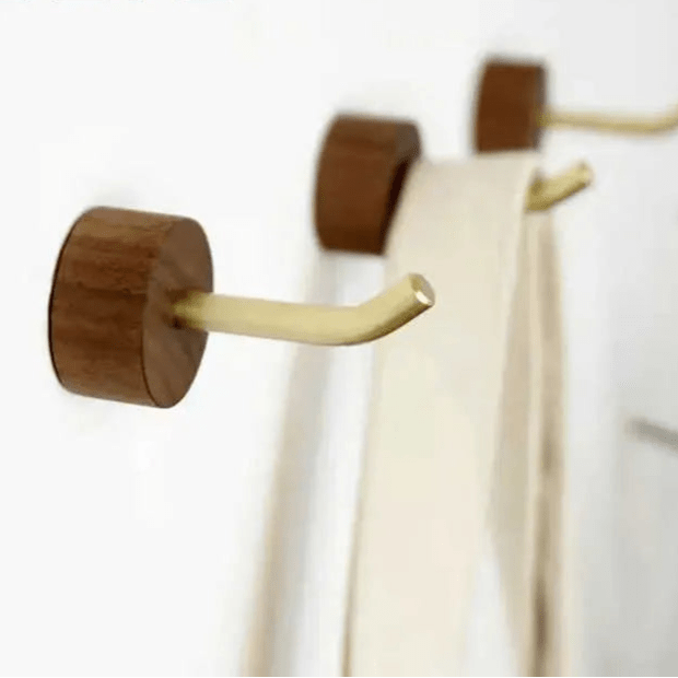Wooden wall hooks displayed on a clean white background, showcasing simple form and natural finish—by Mantara.