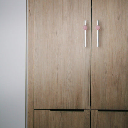 The Mantara C-0027 Calyx Handle is a modern crystal handle in silver and pink, ideal for cabinets, wardrobes, and drawers.
