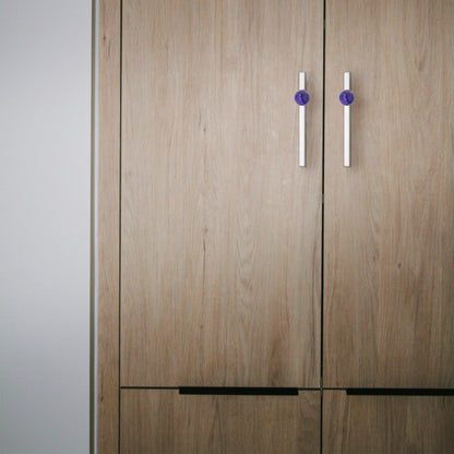 The Mantara C-0027 Calyx Handle is a modern crystal handle in silver and purple, ideal for cabinets, wardrobes, and drawers.